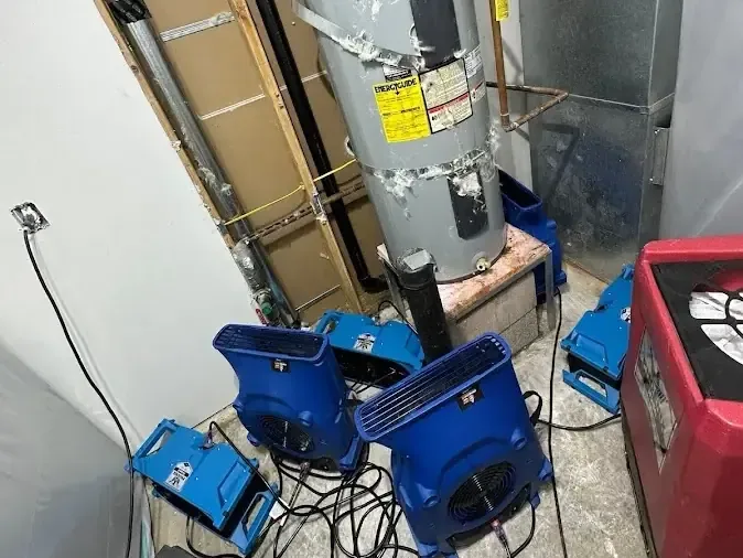 Air movers and a dehumidifier running inside a water heater closet